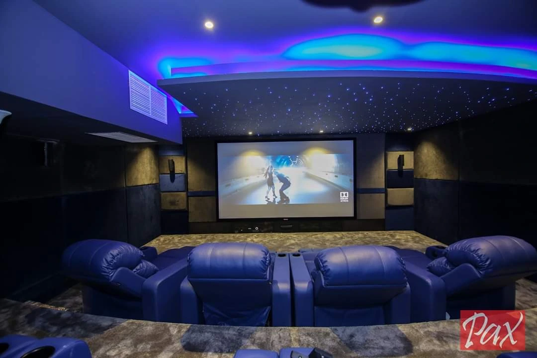 Luxury private home cinema with star ceiling and premium seating